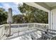 Inviting deck with an umbrella, offering a shaded outdoor space for relaxation and enjoyment of the surrounding greenery at 524 Cobby Creek Ln, Seabrook Island, SC 29455