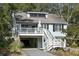 Charming two-story beach home with a covered parking area and a cozy front porch at 524 Cobby Creek Ln, Seabrook Island, SC 29455