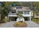 Inviting beach house with a covered parking and exterior stairs leading to a charming porch at 524 Cobby Creek Ln, Seabrook Island, SC 29455