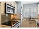 Bright kitchen with granite countertops, stainless steel appliances, and white cabinetry at 524 Cobby Creek Ln, Seabrook Island, SC 29455