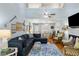 Inviting living room with open concept featuring a large sectional, dining area, and a brick fireplace at 524 Cobby Creek Ln, Seabrook Island, SC 29455