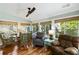 Bright sun room featuring bamboo shades, ceiling fan and comfortable seating area with nature views at 524 Cobby Creek Ln, Seabrook Island, SC 29455