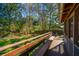 Cozy back porch overlooking the lush, green backyard, with a wooden bench at 6024 Meadowcliff Ave, Hanahan, SC 29410