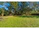Large, grassy backyard bordered by a classic wooden fence and mature trees at 6024 Meadowcliff Ave, Hanahan, SC 29410