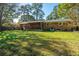 Beautiful backyard showcasing a well-manicured lawn and mature trees at 6024 Meadowcliff Ave, Hanahan, SC 29410
