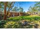Expansive backyard with a brick home, deck and outdoor seating area at 6024 Meadowcliff Ave, Hanahan, SC 29410
