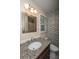 Well-lit bathroom features a granite countertop vanity, decorative mirror, and mosaic tile accent wall at 6024 Meadowcliff Ave, Hanahan, SC 29410