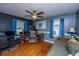 A blue themed bedroom with a daybed, ceiling fan, blue curtains and hardwood floors at 6024 Meadowcliff Ave, Hanahan, SC 29410