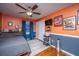 Orange and blue bedroom featuring a large window, ceiling fan, hardwood floors and closet with double doors at 6024 Meadowcliff Ave, Hanahan, SC 29410