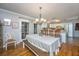 Bright dining area featuring a wooden table, chandelier, and view of the kitchen at 6024 Meadowcliff Ave, Hanahan, SC 29410