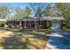 Charming brick house with a well-maintained front yard, mature trees, and a two-car garage at 6024 Meadowcliff Ave, Hanahan, SC 29410
