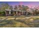 Charming brick home with a well-maintained lawn and inviting front porch at 6024 Meadowcliff Ave, Hanahan, SC 29410