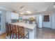 Bright kitchen features a large center island with seating, white cabinets, and stainless steel appliances at 6024 Meadowcliff Ave, Hanahan, SC 29410