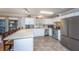 Bright kitchen features white cabinets, stainless steel appliances, and a view to the outside through large windows at 6024 Meadowcliff Ave, Hanahan, SC 29410