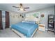 Cozy bedroom with a queen bed, ceiling fan, neutral walls, and hat decorations for a personal touch at 6024 Meadowcliff Ave, Hanahan, SC 29410