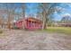 Spacious back yard featuring a large covered deck, lush green grass, and mature trees around the perimeter at 7 Dogwood Ln, Walterboro, SC 29488