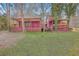 Expansive backyard with an outdoor patio, covered deck, and lush greenery surrounding the property at 7 Dogwood Ln, Walterboro, SC 29488
