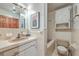 Traditional bathroom featuring a tiled countertop sink, with a built-in tub and white-tiled walls at 7 Dogwood Ln, Walterboro, SC 29488