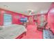 Spacious bedroom with red walls and carpet, featuring a ceiling fan and large windows for natural light at 7 Dogwood Ln, Walterboro, SC 29488