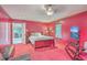 Large red bedroom with a bed, window, doorway, and a television on a stand at 7 Dogwood Ln, Walterboro, SC 29488