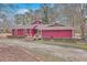 The front of this red house has beautiful landscaping, mature trees and a well-manicured front garden area at 7 Dogwood Ln, Walterboro, SC 29488