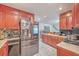 Cherry wood kitchen cabinets and stainless steel refrigerator at 7 Dogwood Ln, Walterboro, SC 29488