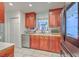 Kitchen featuring cherry cabinets, a stainless steel fridge, and sink at 7 Dogwood Ln, Walterboro, SC 29488