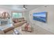 Cozy living room featuring comfortable seating, a fireplace, large TV, and ample natural light at 7 Dogwood Ln, Walterboro, SC 29488