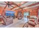 Cozy living room with wood paneling, ceiling beams, and a comfortable leather sofa set at 7 Dogwood Ln, Walterboro, SC 29488