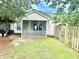 Enclosed backyard featuring a screened patio, light siding, a grill and a wood fence at 7364 Suncatcher Dr, Hanahan, SC 29410