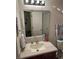 Cozy bathroom with a granite vanity, bright lighting, and nautical decor at 7364 Suncatcher Dr, Hanahan, SC 29410