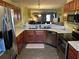 Bright kitchen with stainless steel appliances, wood cabinets, and an open view to the living area at 7364 Suncatcher Dr, Hanahan, SC 29410
