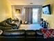 Comfortable living room with plush seating, a large rug, and sliding glass doors to the backyard at 7364 Suncatcher Dr, Hanahan, SC 29410