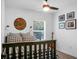 Bright bedroom featuring a ceiling fan, a window, and minimalist decor on the white walls at 781 E Butternut Rd, Summerville, SC 29483