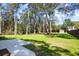 Expansive backyard features mature trees, a well maintained lawn, and a concrete patio at 782 Bonham Dr, Charleston, SC 29412