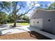 Side view of the home features a two car garage and long driveway framed by trees and nice landscaping at 782 Bonham Dr, Charleston, SC 29412