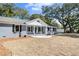 Charming home with a brick facade, complemented by black shutters and lush green trees at 782 Bonham Dr, Charleston, SC 29412