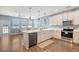 A modern kitchen with white cabinetry, stainless steel appliances, an island, and hardwood floors at 7857 Montview Rd, North Charleston, SC 29418