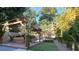 Serene backyard features a covered pergola, lush greenery, and a glimpse of the inviting swimming pool at 80 Smith St, Charleston, SC 29401