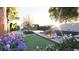 Landscaped backyard featuring a swimming pool, outdoor seating areas, and lush flowering plants at 80 Smith St, Charleston, SC 29401