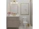 Elegant bathroom with gold fixtures, a marble countertop, and a framed floral print at 80 Smith St, Charleston, SC 29401
