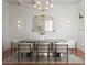 Elegant dining room with a modern table, stylish chairs, chandelier, ornate mirror, and a patterned rug at 80 Smith St, Charleston, SC 29401