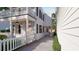 White two-story home with a side driveway and well-manicured green bushes at 80 Smith St, Charleston, SC 29401