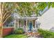 Inviting two-story home with a covered front porch and a lush front yard at 80 Smith St, Charleston, SC 29401
