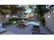 Wonderful backyard features a pool, lounge chairs, comfortable seating, a fire pit, and mature landscaping at 80 Smith St, Charleston, SC 29401