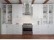 Bright, modern kitchen featuring white cabinetry, stainless appliances, gold hardware, and subway tile backsplash at 80 Smith St, Charleston, SC 29401