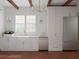 Bright, modern kitchen featuring white cabinetry, a farmhouse sink, gold hardware and stainless appliances at 80 Smith St, Charleston, SC 29401