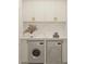 Modern laundry room featuring white cabinets, marble countertops, and side by side washer and dryer at 80 Smith St, Charleston, SC 29401