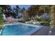 Luxurious pool and patio area with outdoor seating, sun loungers, and a cozy fireplace feature at 80 Smith St, Charleston, SC 29401