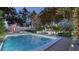 Elegant pool and patio area with comfortable seating, sun loungers, and a charming outdoor fireplace at 80 Smith St, Charleston, SC 29401